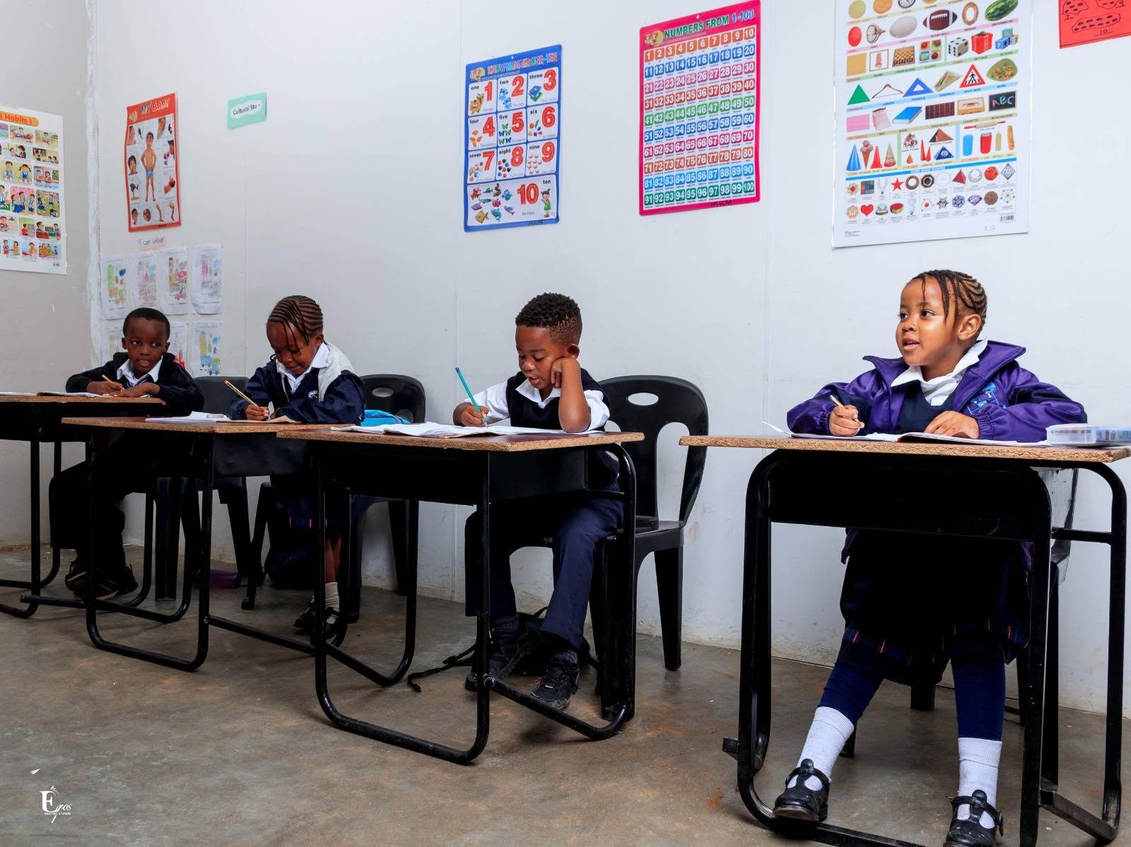 Elyte learners learning together in a bright classroom